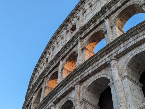 Capture of the Colosseum's architectural details during a beautiful sunset in Rome, Italy.