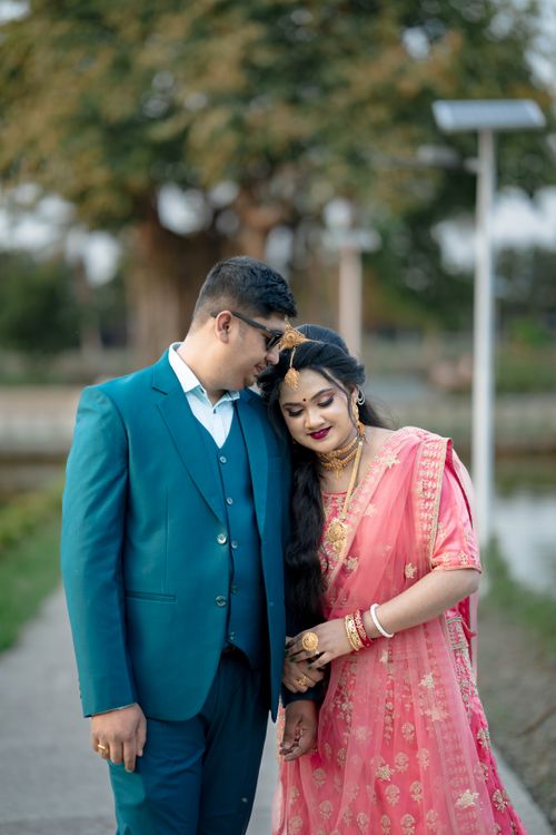 Romantic Couple Embracing Outdoors in Traditional Attire · Free Stock Photo