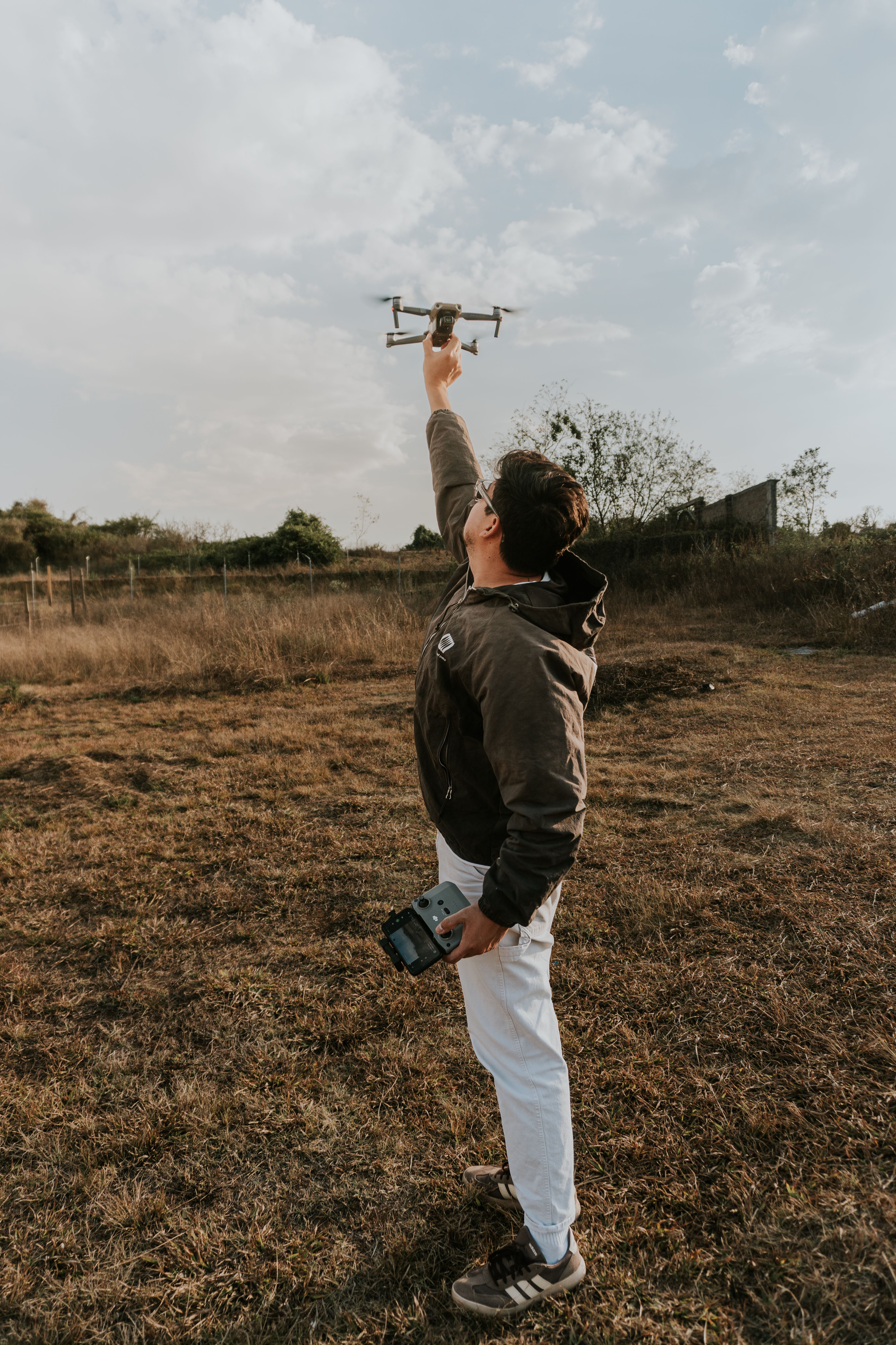 Man Flying Drone in Open Field at Daytime · Free Stock Photo