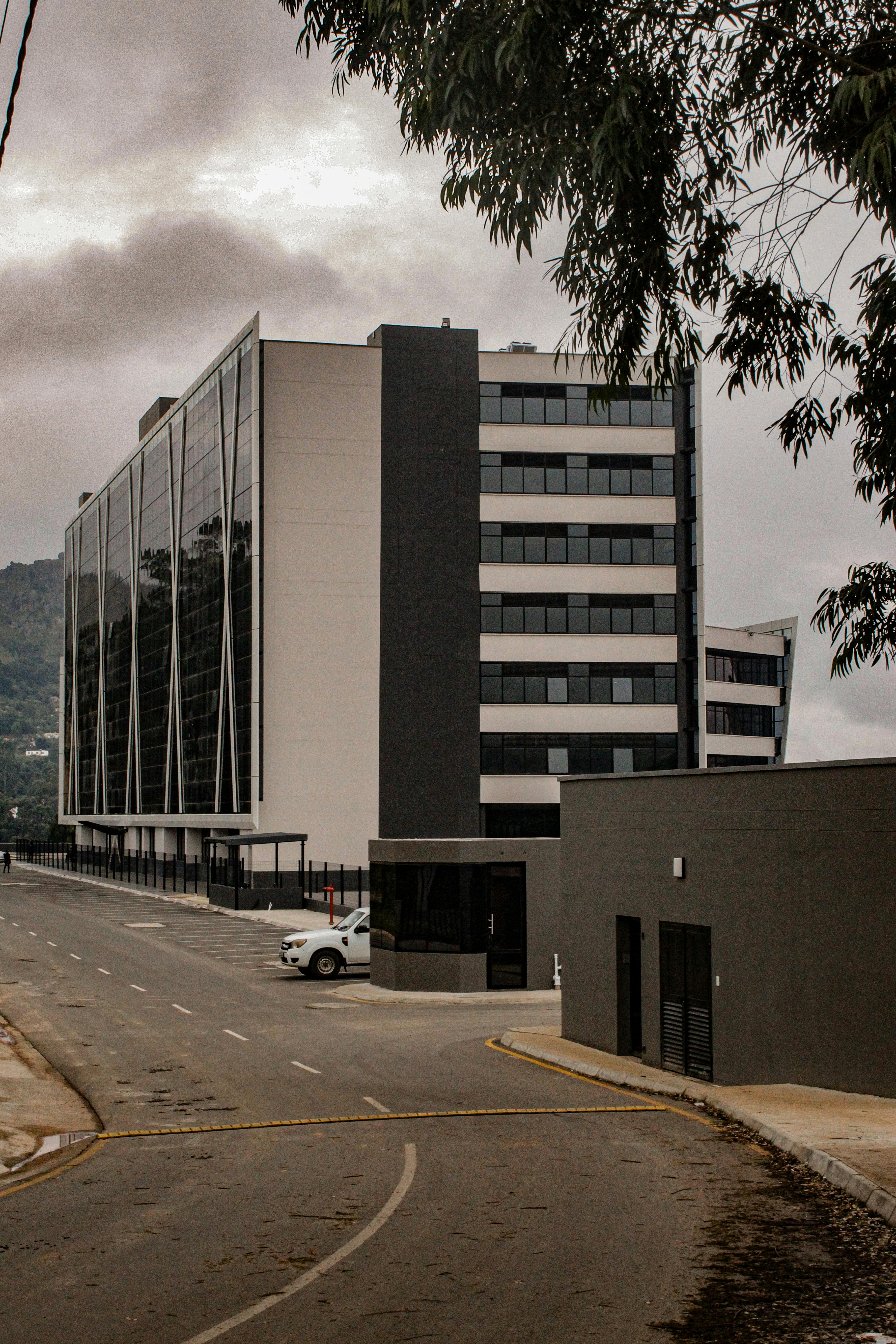A modern office building with glass facades in Mbabane, Eswatini on a cloudy day.