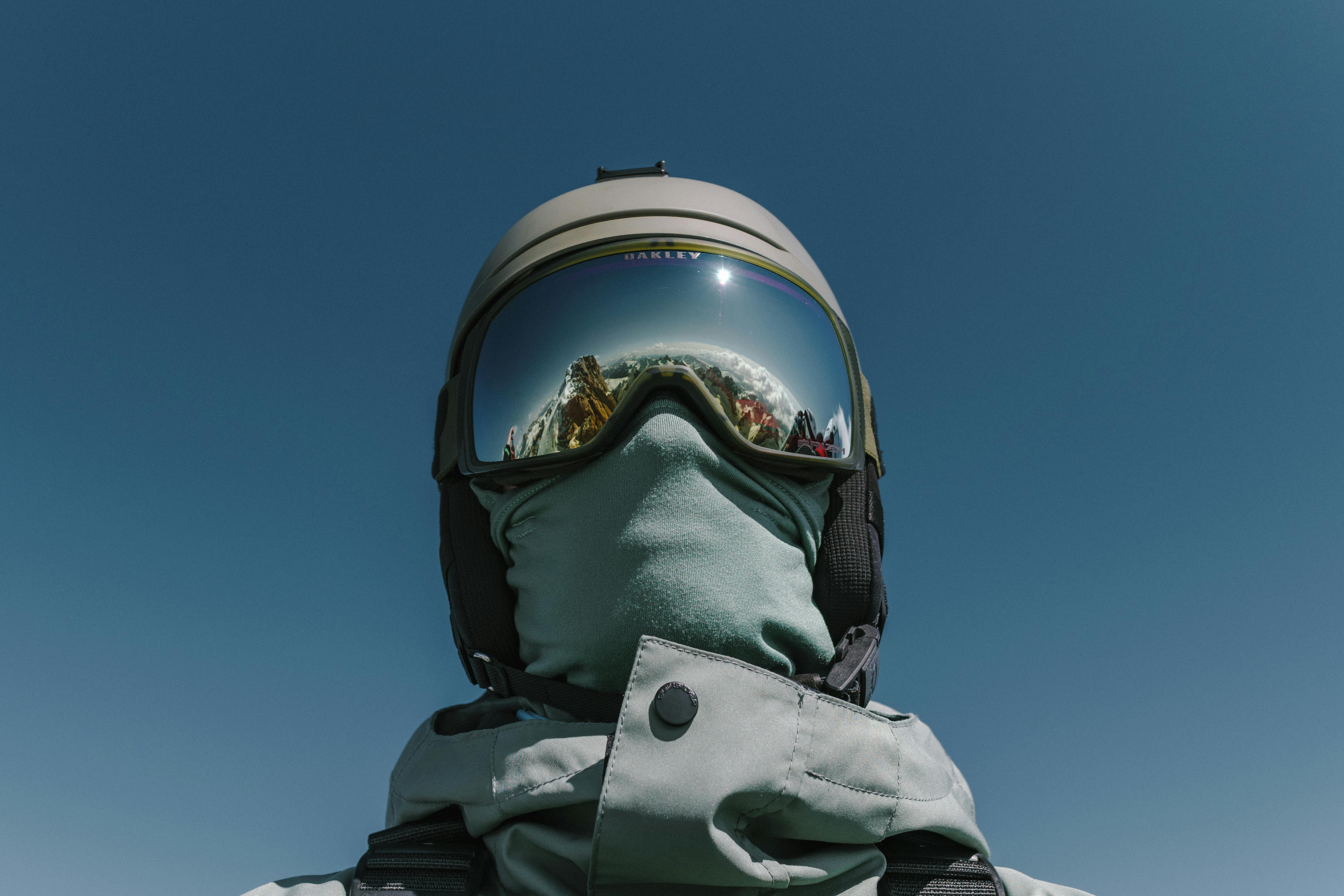Free Ski enthusiast in winter gear with mountain reflection in goggles at Campitello di Fassa, Italy. Stock Photo