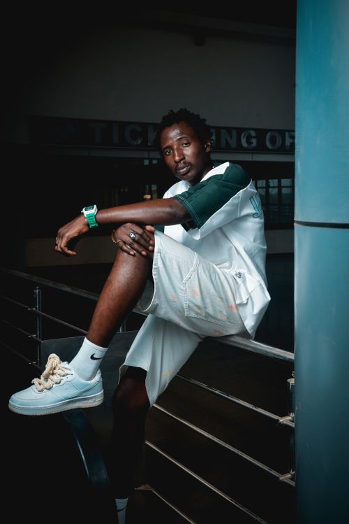 Free A fashionable man poses confidently in a modern urban environment, showcasing contemporary streetwear style. Stock Photo