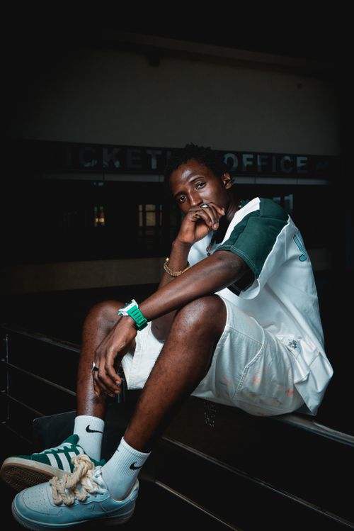 Free Stylish young man posing indoors, wearing casual sportswear and sneakers. Stock Photo