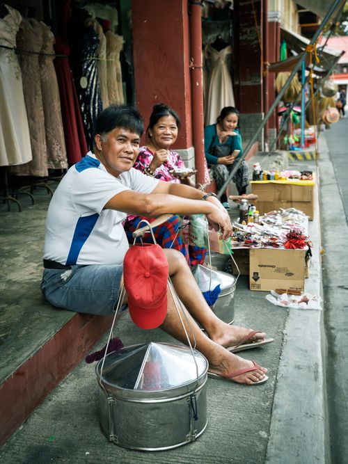Free Lively scene of friendly street vendors offering traditional Filipino taho in Taal, Philippines. Stock Photo
