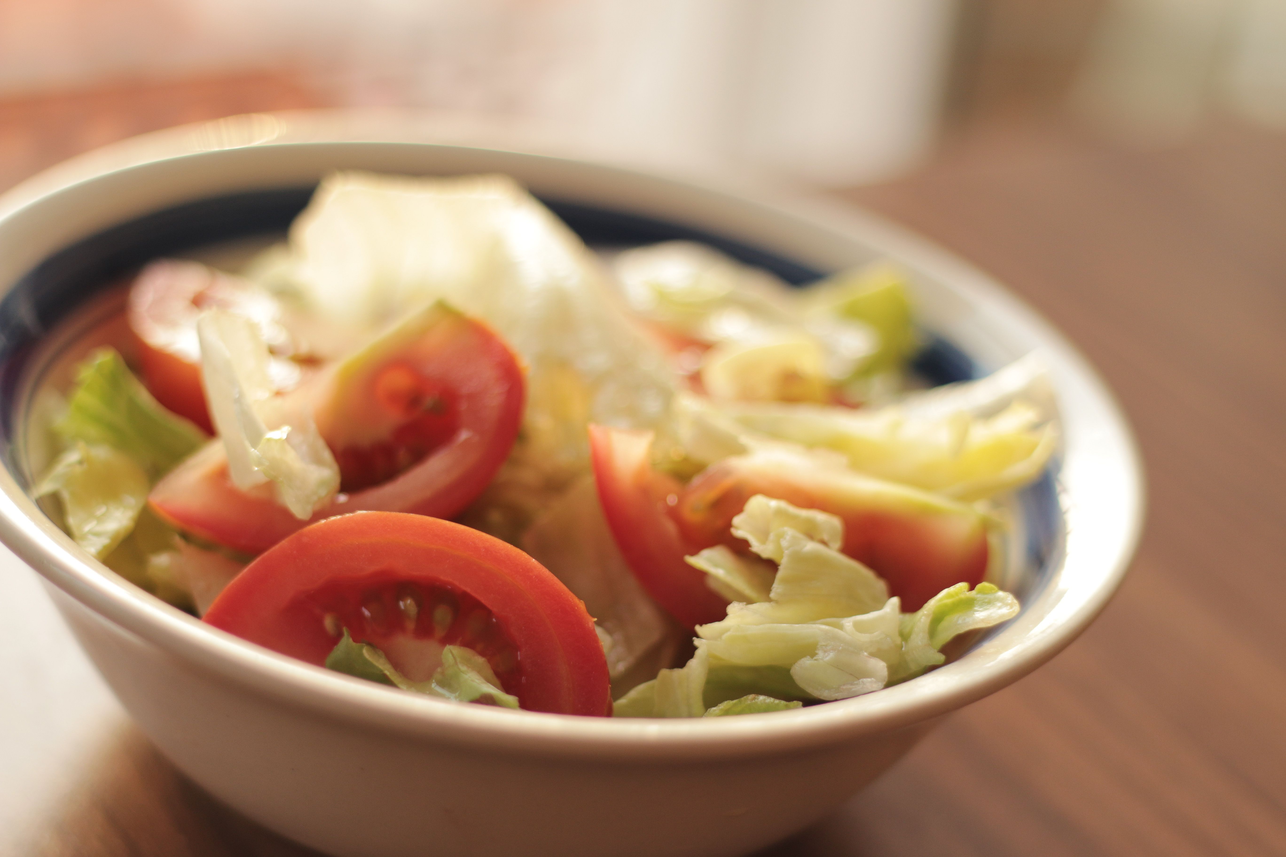 Close-up of a fresh vegetable salad with tomatoes and lettuce in a bowl.