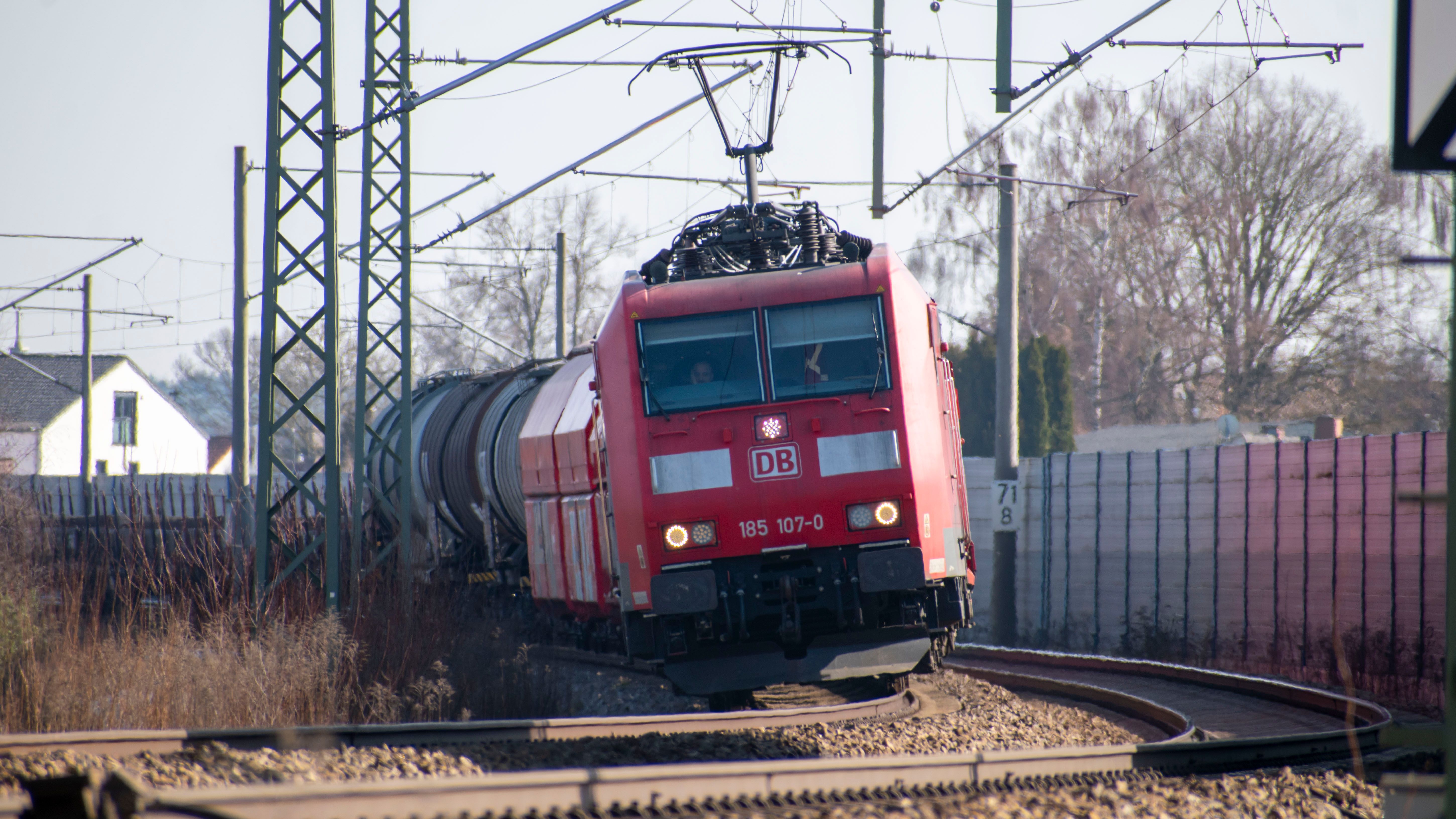Red Freight Train on Curved Railway Track Outdoors · Free Stock Photo