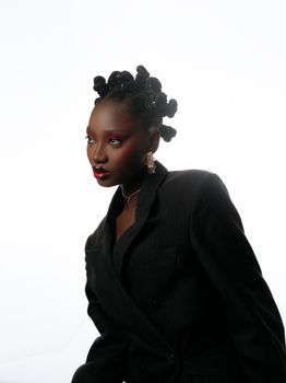 Stylish portrait of an adult woman with unique hairstyle in a black blazer.
