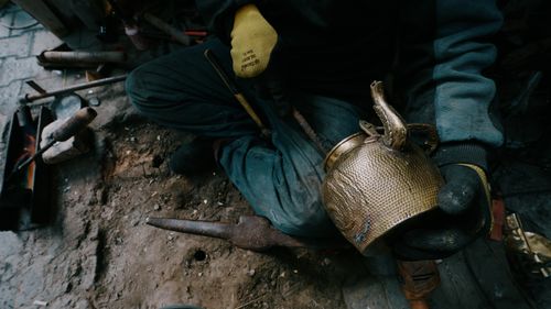 Free A skilled artisan working on a brass teapot in a traditional workshop, highlighting craftsmanship. Stock Photo