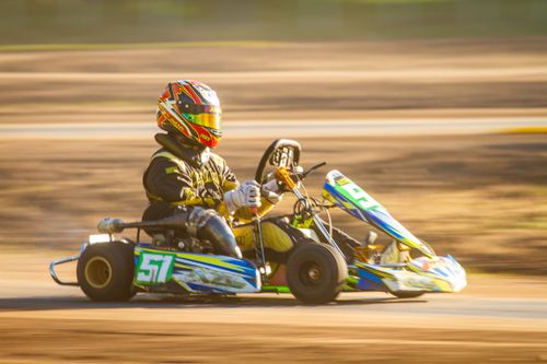 Free Young racer in vibrant gear driving a go-kart swiftly around a track in Bragado, Argentina. Stock Photo