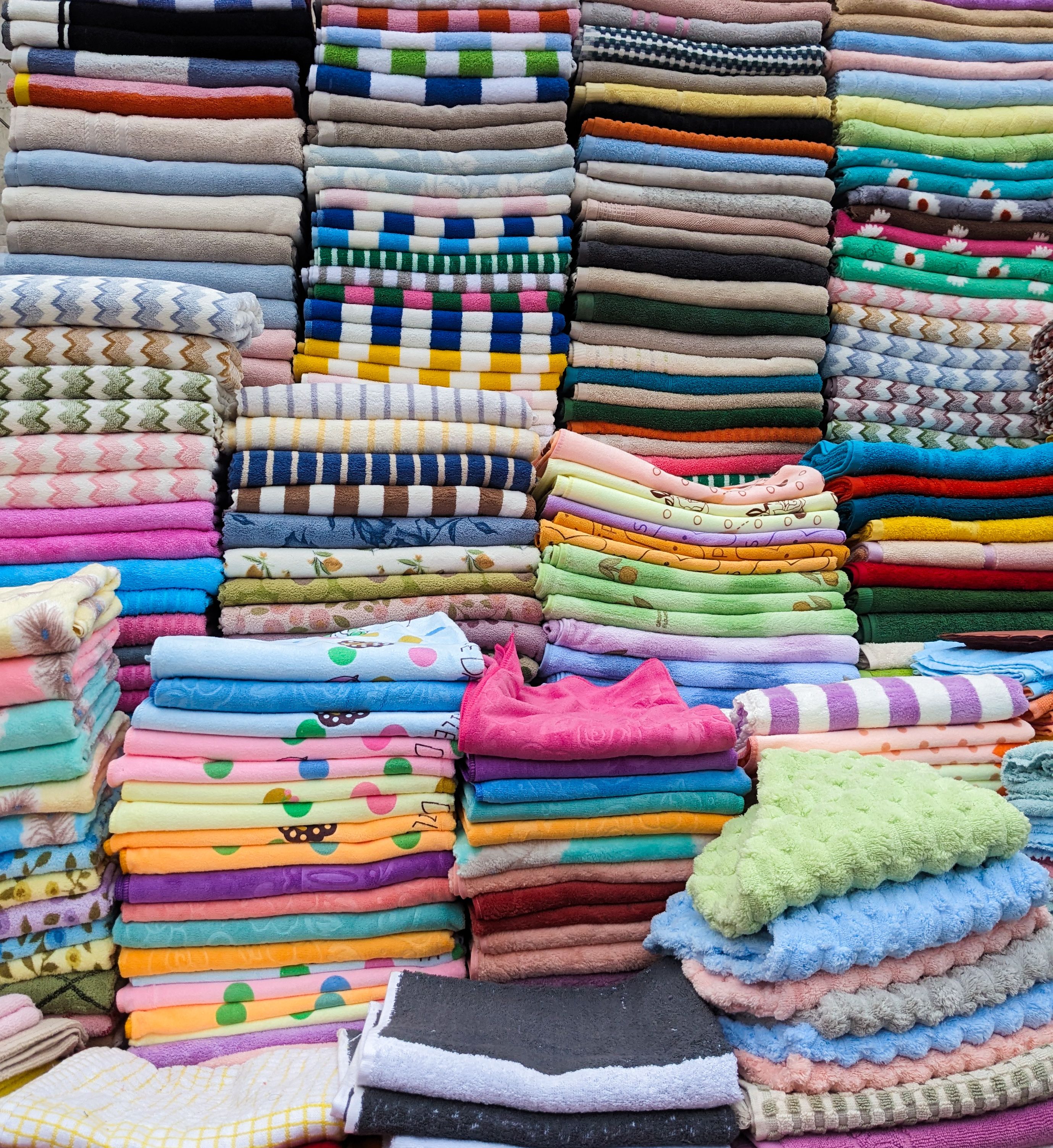Colorful Stack of Folded Fabrics in Textile Market · Free Stock Photo