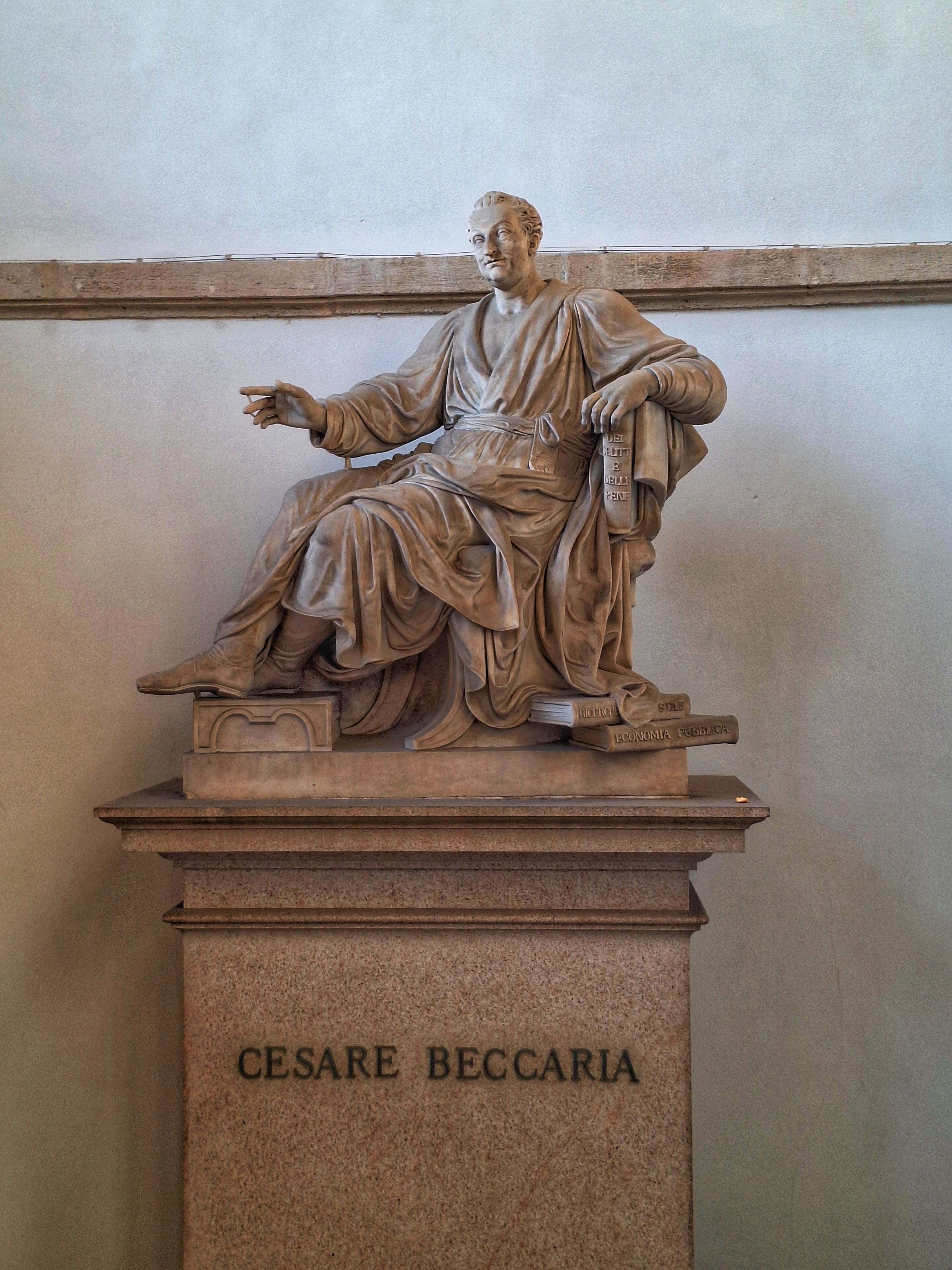 Elegant marble statue of Cesare Beccaria located in a Milano museum, showcasing classic artistry.
