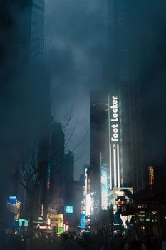 Foggy city night with bright advertisements lighting up tall buildings on an urban street.