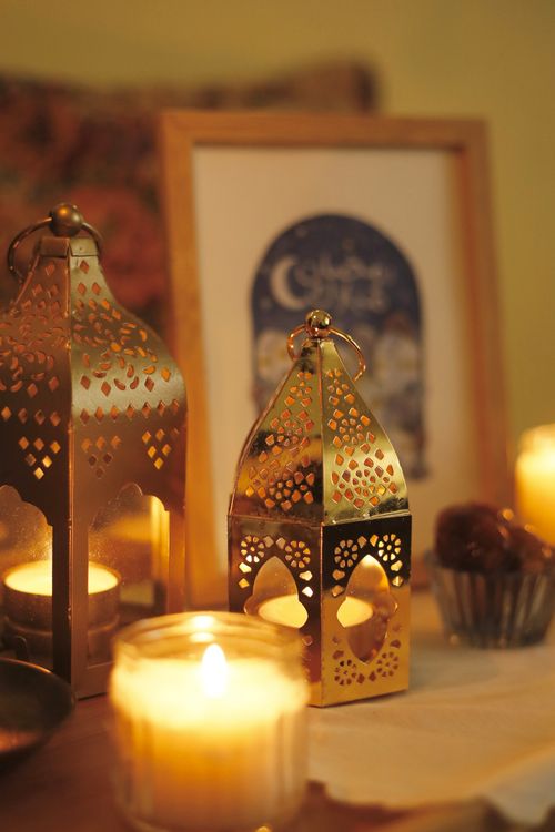 Free Beautifully lit Ramadan lanterns with candles in a warm ambiance, perfect for festive settings. Stock Photo