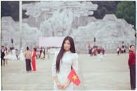 Vietnamese Woman Holding Flag at Landmark Site