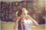 Schoolgirl poses playfully in sunny classroom