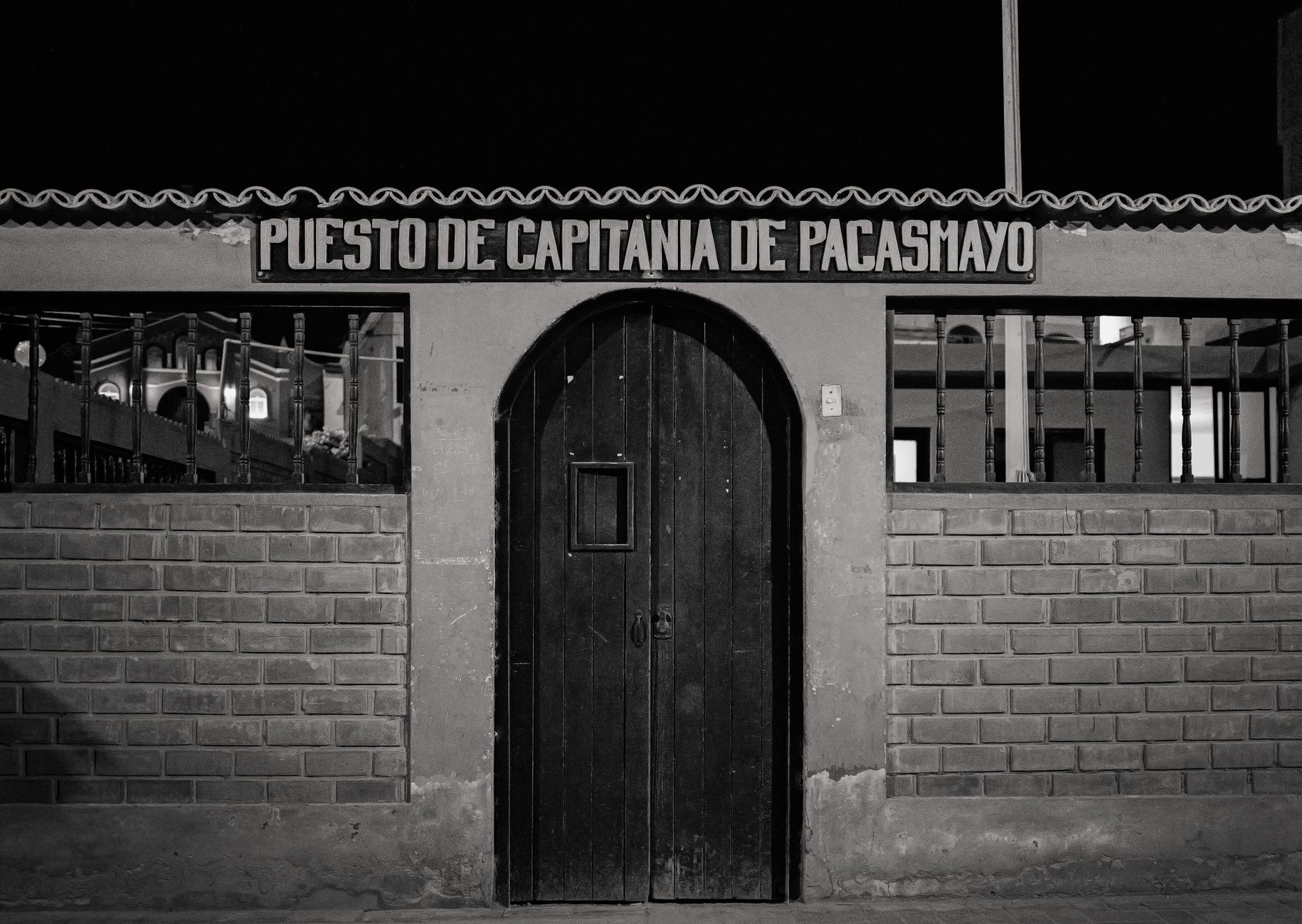 Black and white photo of Puesto De Capitanía de Pacasmayo at night, Peru.