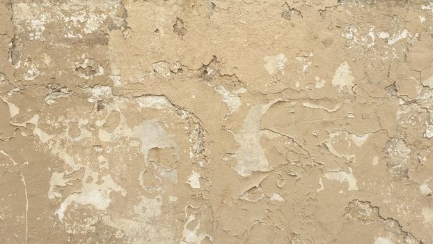 A rustic wall with peeling paint and textured surface, ideal for backgrounds and design projects.