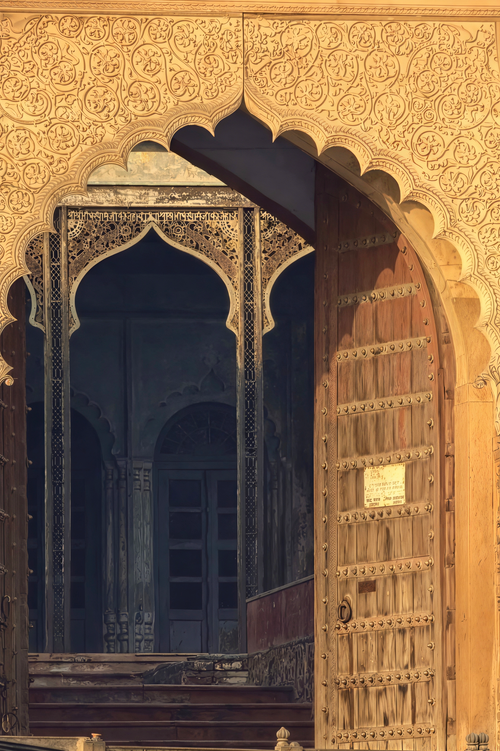 Free Beautifully carved wooden doorway leading to an ancient structure in Mathura, India. Stock Photo