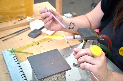 Free Closeup of artisan crafting glass piece with torch in Spanish workshop. Stock Photo