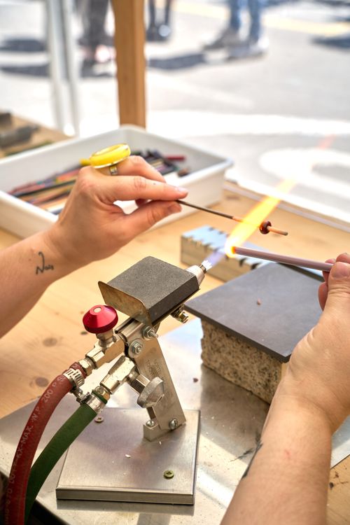 Free Craftsperson creating art with glassblowing torch in Tudela de Duero, Spain. Stock Photo