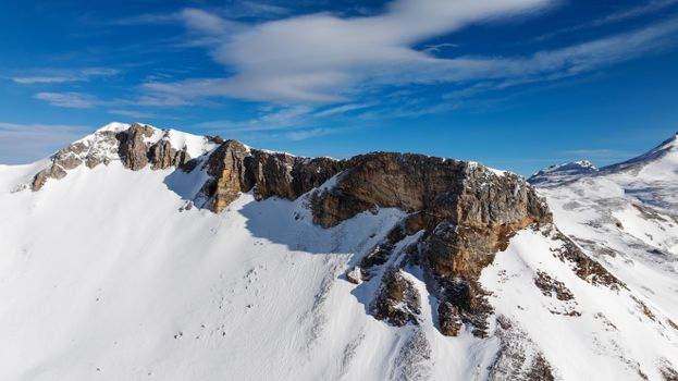 A breathtaking aerial view of the snow-covered Hochtor mountains under a clear blue sky.