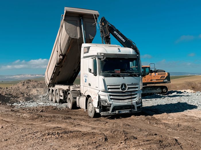 Dump truck and excavator at construction site