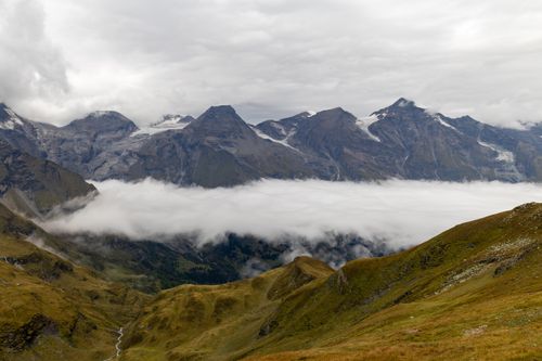 Free Breathtaking view of snow-capped Hochtor peaks in Austria, surrounded by clouds and lush valleys. Stock Photo