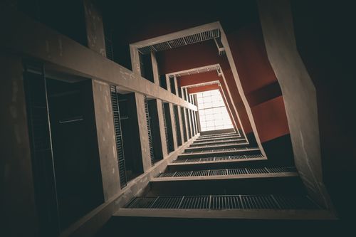 Free Vertigo-inducing view of an interior architectural space looking up towards a skylight. Stock Photo