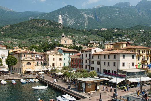 Explore the picturesque landscape of Lake Garda with colorful buildings and lush hills.