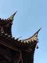 Traditional Asian Temple Roof Against Blue Sky