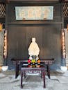 Traditional Asian Shrine with Statue and Offerings