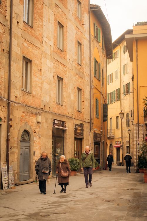 Free Senior adults enjoying a peaceful stroll in historic Pisa, Tuscany. Stock Photo