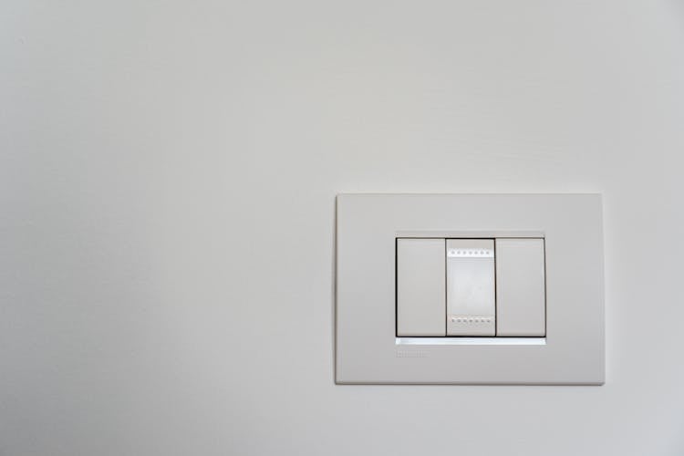 White Light Switch On White Painted Wall