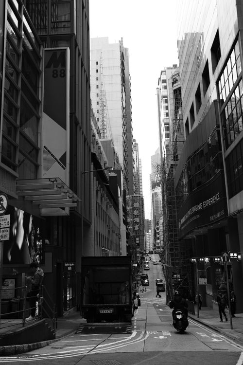 Free Dynamic black and white city street scene with skyscrapers and bustling street life. Stock Photo