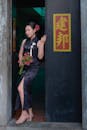 Elegant Woman in Cheongsam Holding Floral Bouquet