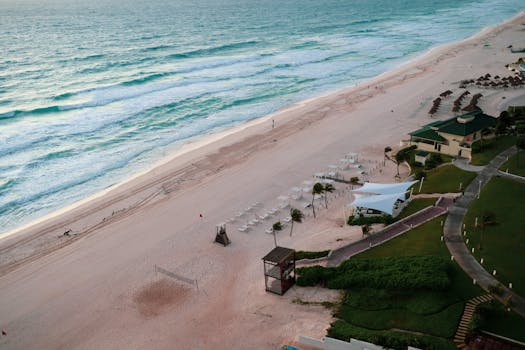 Serene aerial view of Cancun's beautiful beachfront with turquoise waters and sandy shores.