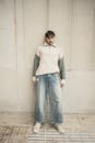 Casual Urban Fashion Portrait Against Wall