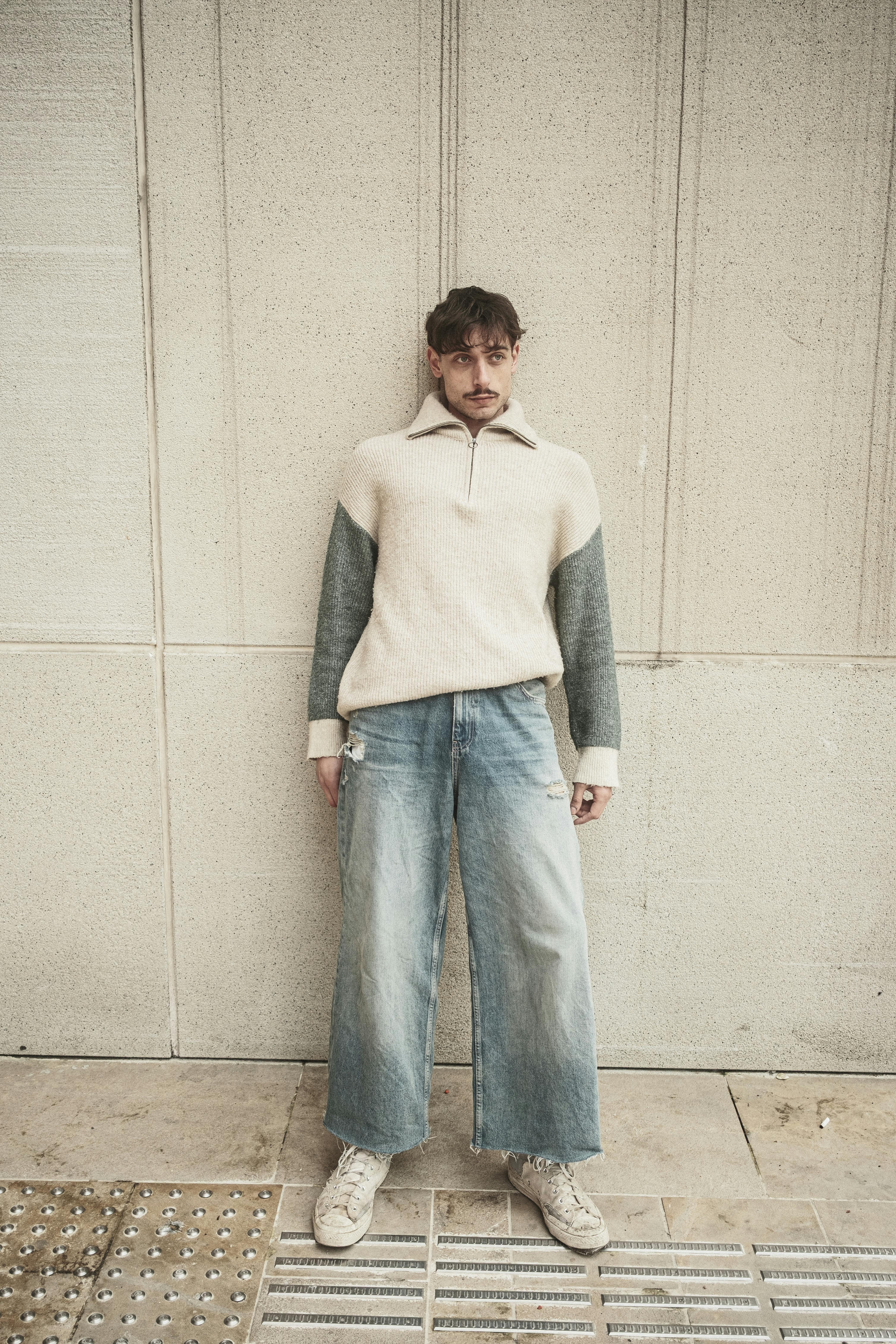 Casual Urban Fashion Portrait Against Wall