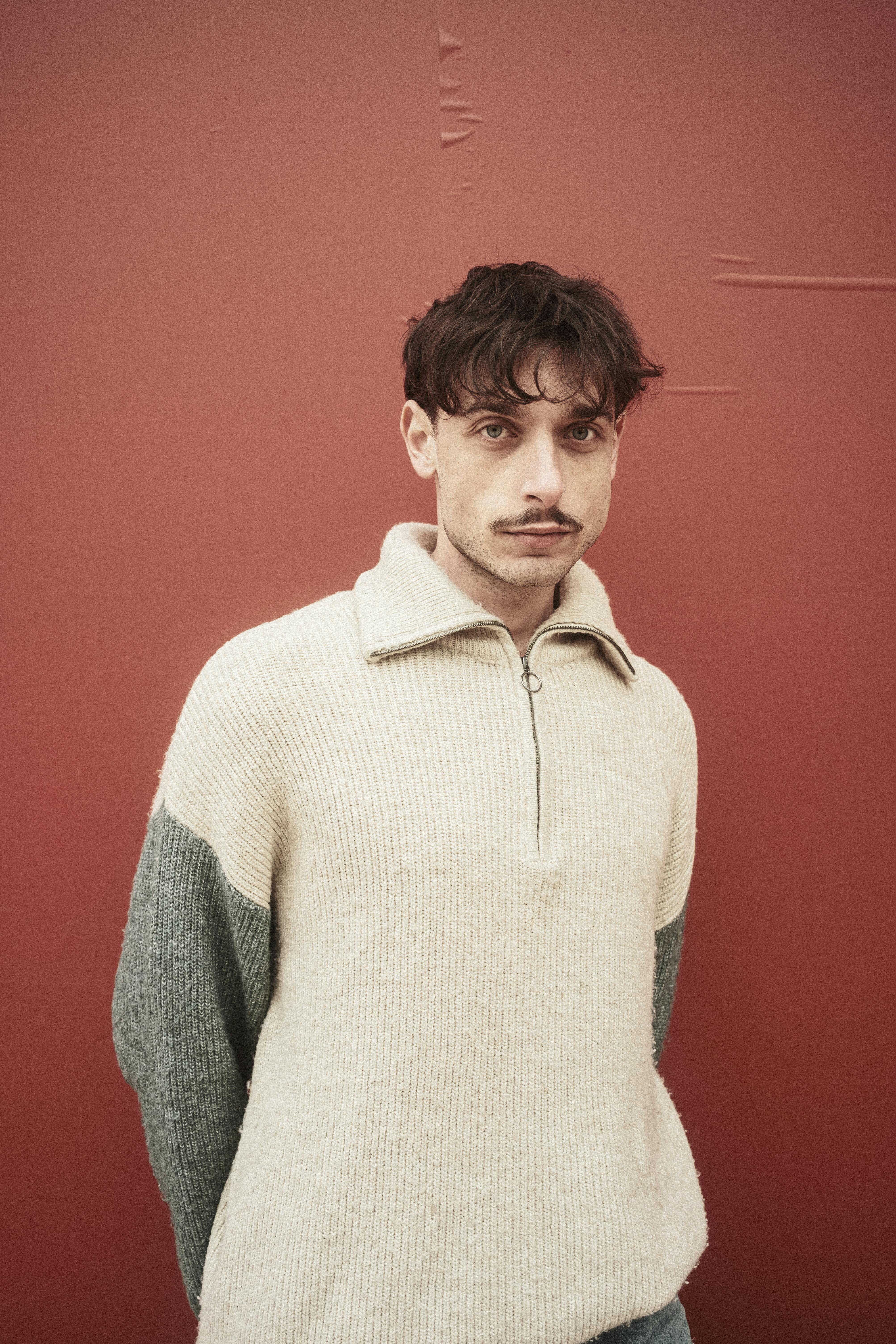 Portrait of a man against a textured wall