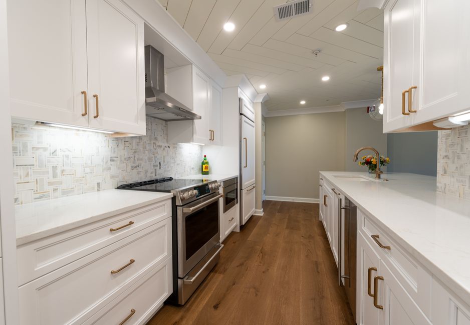 Contemporary kitchen renovation with white cabinetry