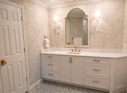 Free Elegant bathroom with white vanity, mirror, and soft lighting creating a luxurious ambiance. Stock Photo