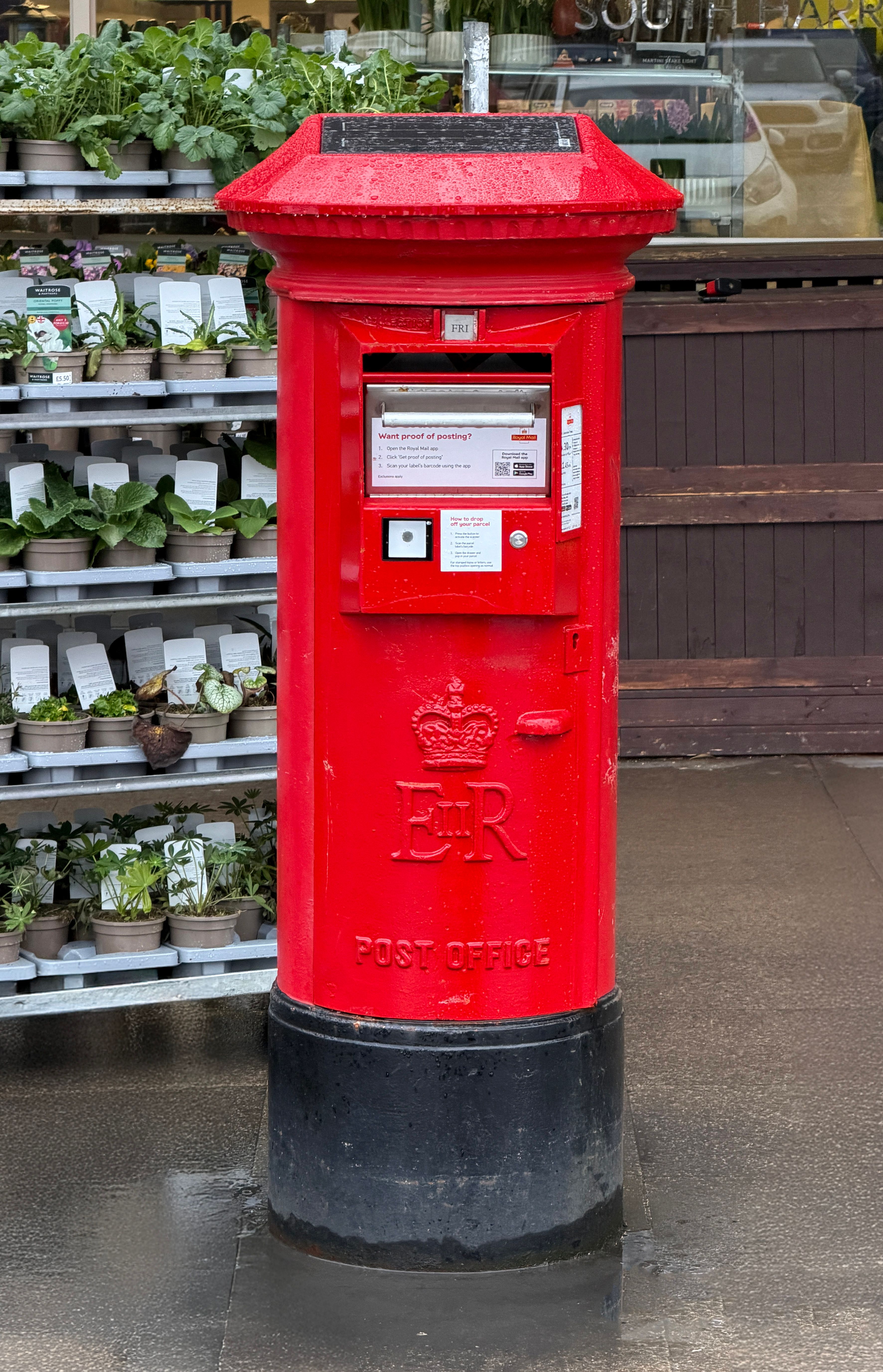 Iconic Red UK Post Box on Rainy Day · Free Stock Photo