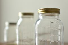 Three glass jars with gold lids showcased for eco-friendly kitchen storage.