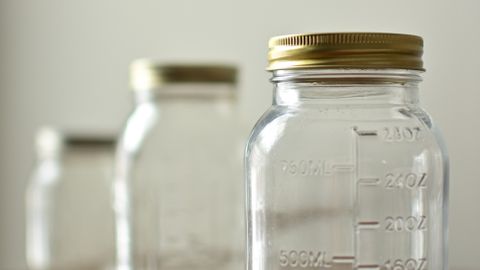 Three glass jars with gold lids showcased for eco-friendly kitchen storage.