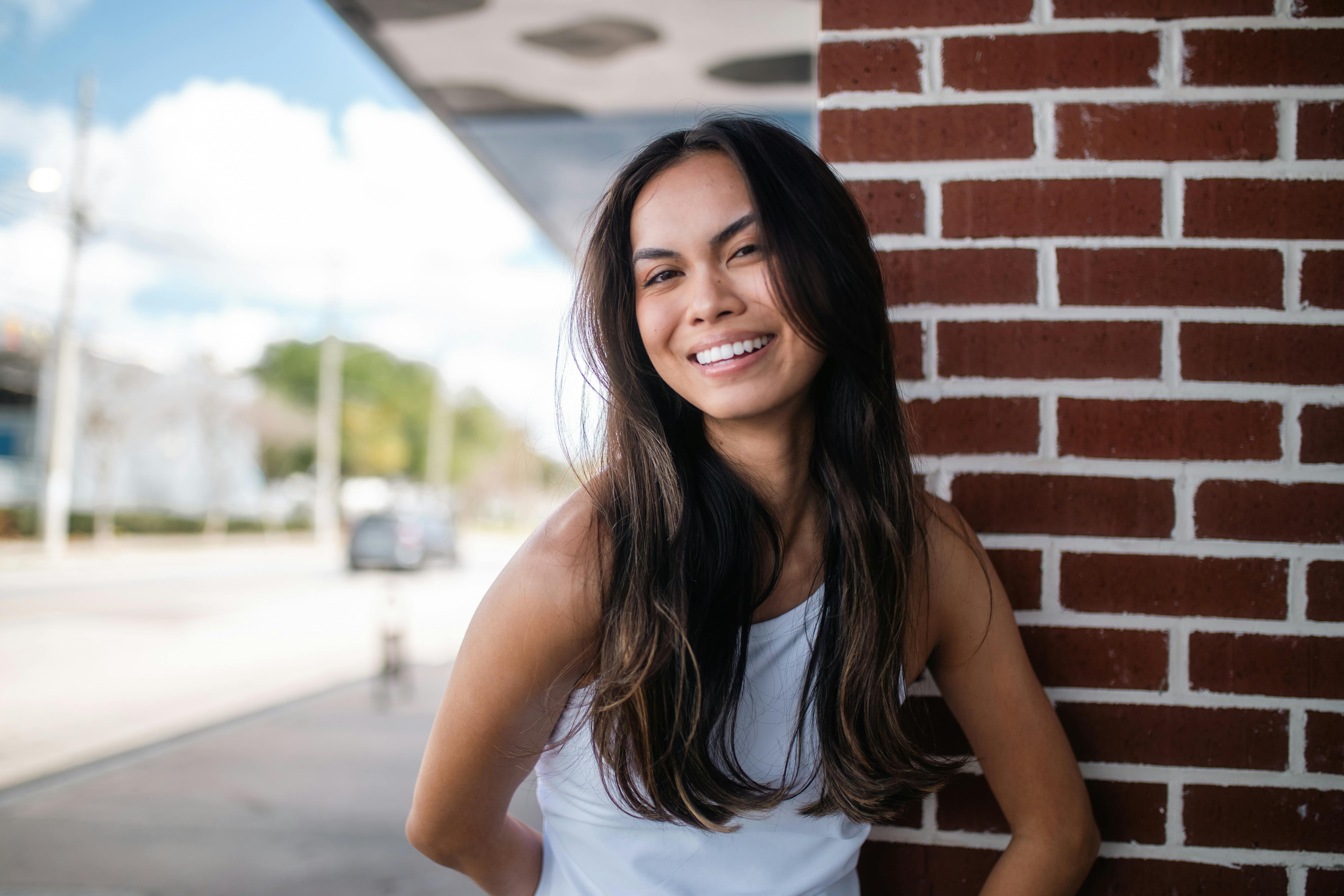 Hispanic woman comparing car insurance quotes on smartphone in Orlando Florida