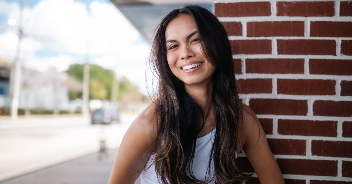 Hispanic woman comparing car insurance quotes on smartphone in Orlando Florida