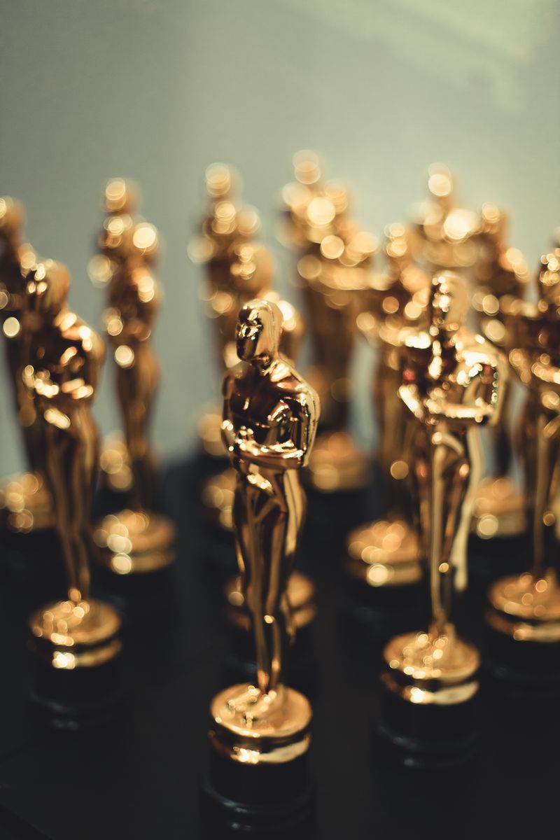 Close-up of multiple golden award statuettes on display, capturing elegance and prestige.