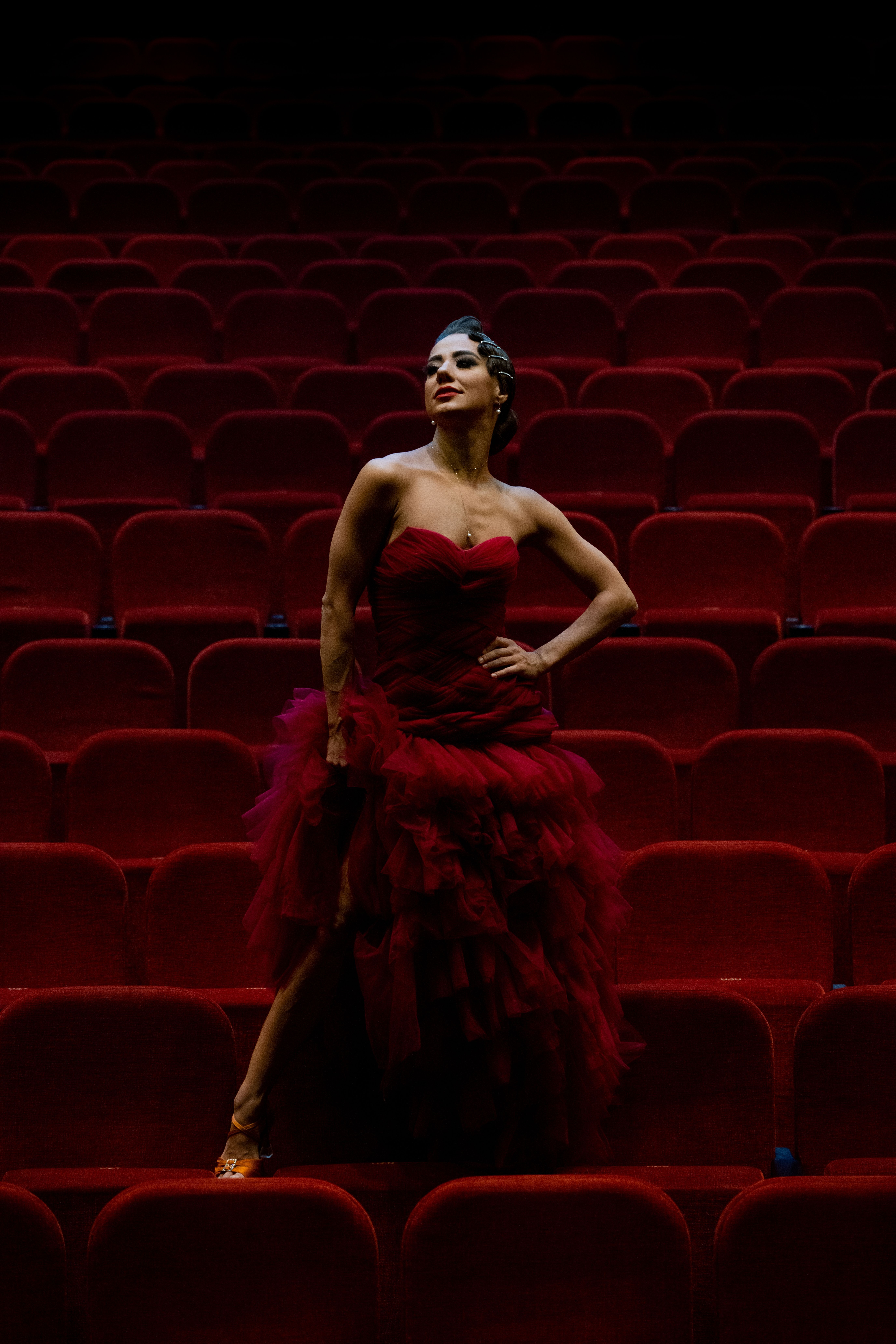 Elegant Woman in Red Dress at Theater · Free Stock Photo