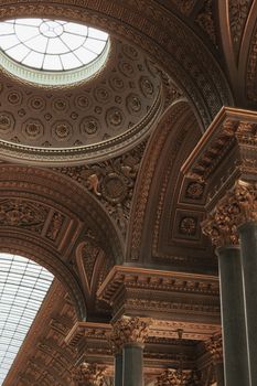 Intricate arches and columns inside a grand Parisian building, showcasing stunning architecture.