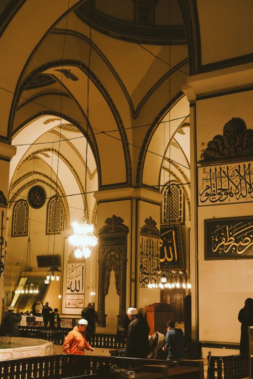 Free A warm view of Ulu Mosque's interior in Bursa, featuring Islamic calligraphy and architecture. Stock Photo